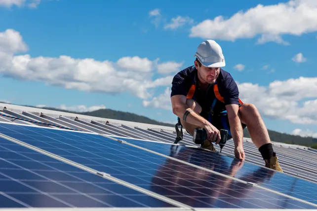 Solar installer working on rooftop